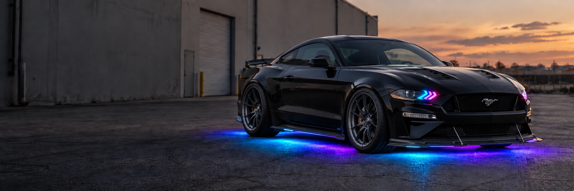 Illustration of a modified Mustang with multicolor DRLs and cyan, violet and magenta underglow